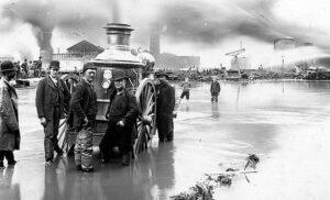 Chief engineer James Lee (and others stand next to the Colonel Drake Steam Pumper during the Great Flood and Fire of 1892